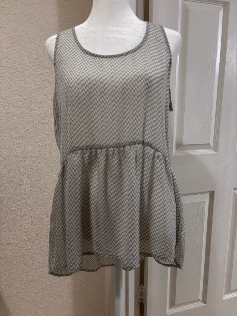 Sleeveless Black & White Printed Peplum Blouse
